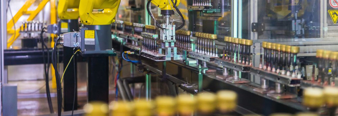 Inline vacuum metallizing production line with robotic automation for bottle caps at Marca Coatings Technologies.